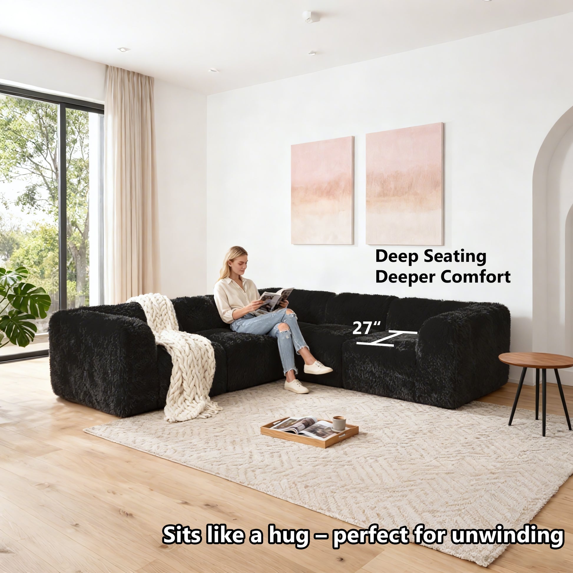 Black Sofa with Dual Arms showcases its deep seating design– a lady comfortably enjoys reading time on the sofa