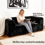 Black Modular Loveseat showcases its deep seating design– a lady comfortably enjoys reading time on the sofa