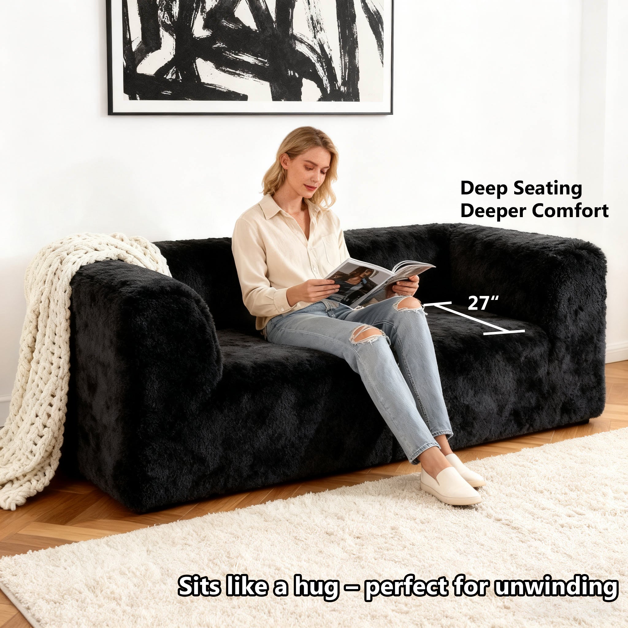 Black Modular Loveseat showcases its deep seating design– a lady comfortably enjoys reading time on the sofa