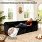 Black Modular Loveseat with its rounded armrests and high-density foam support – a lady is comfortably relaxing on the sofa