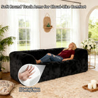 Black Modular Loveseat with its rounded armrests and high-density foam support – a lady is comfortably relaxing on the sofa