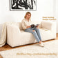 Soft sand Modular Loveseat showcases its deep seating design– a lady comfortably enjoys reading time on the sofa