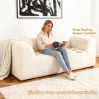 Soft sand Modular Loveseat showcases its deep seating design– a lady comfortably enjoys reading time on the sofa