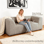 Taupe gray Modular Loveseat showcases its deep seating design– a lady comfortably enjoys reading time on the sofa