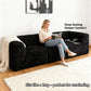 Black-colored sofa showcases its deep seating design– a lady comfortably enjoys reading time on the sofa.