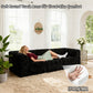 Black sofa with its rounded armrests and high-density foam support – a ladyis comfortably relaxing on the sofa.