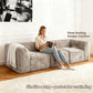 Taupe gray-colored sofa showcases its deep seating design– a lady comfortably enjoys reading time on the sofa.